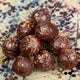 Chocolate truffles on a decorative plate with a speckled pattern