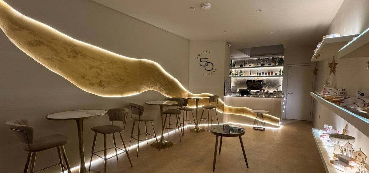 Molton50 café interior with an illuminated sculptural gold wall